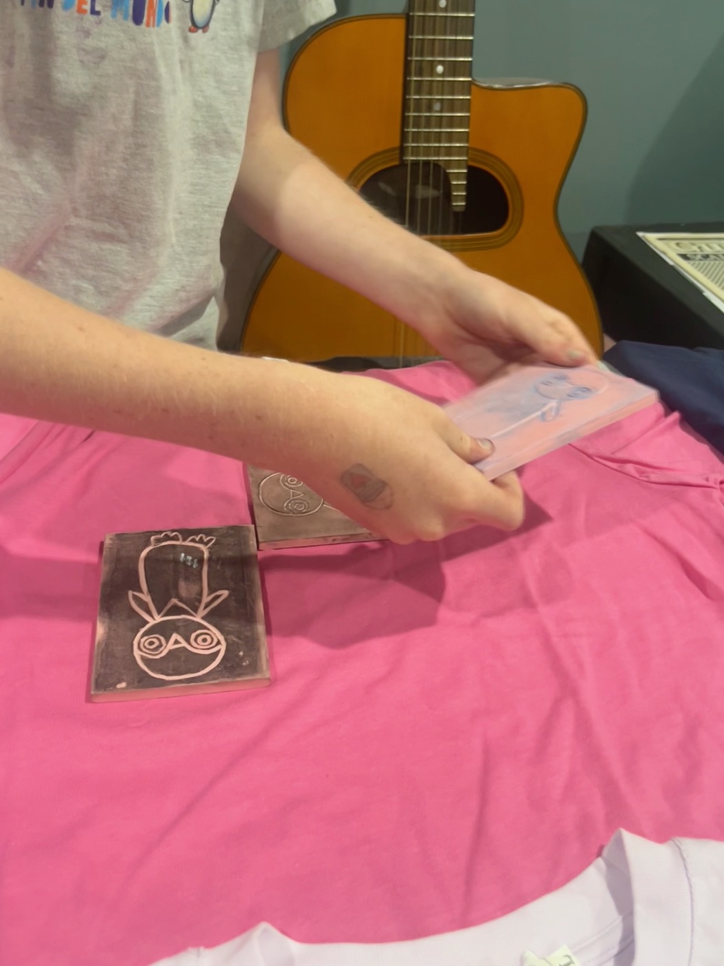 Pressing the linocut block onto the shirt