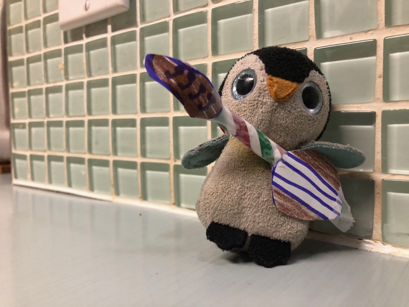 Pengi the rock star playing a hand-drawn paper guitar